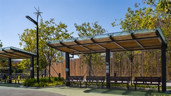 Bamboo-themed rain shelters offer ample shade for visitors and echoes with the bamboo fence at the park boundary.